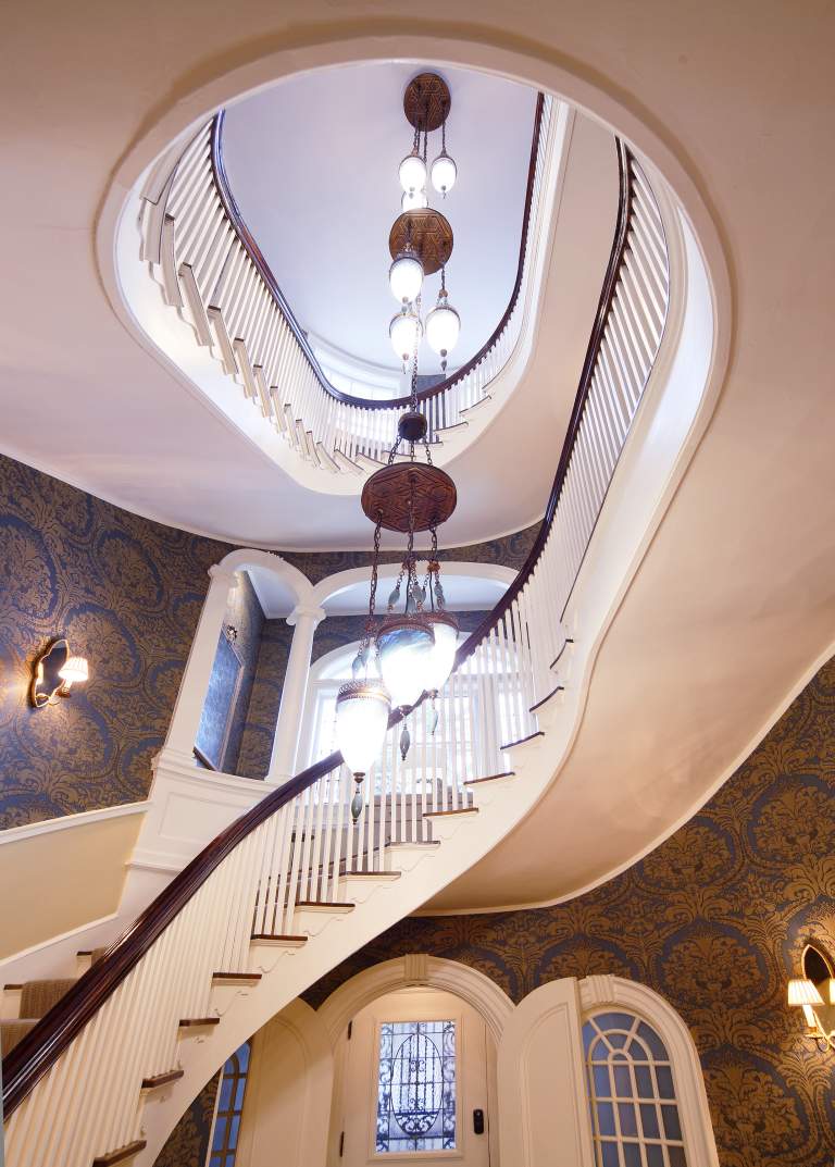 Oval staircase two story interior light fixture