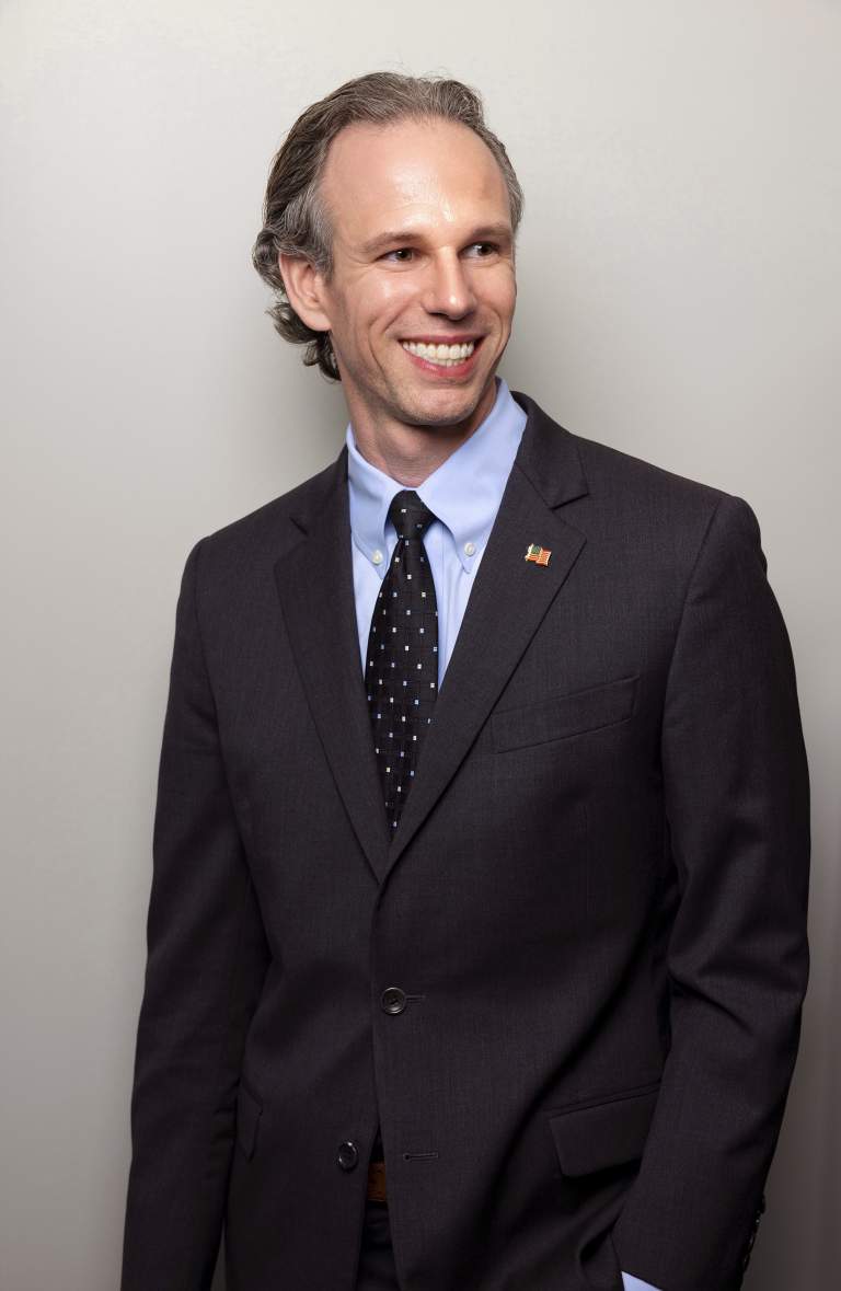 relaxed smiling intellectual property attorney looking off camera