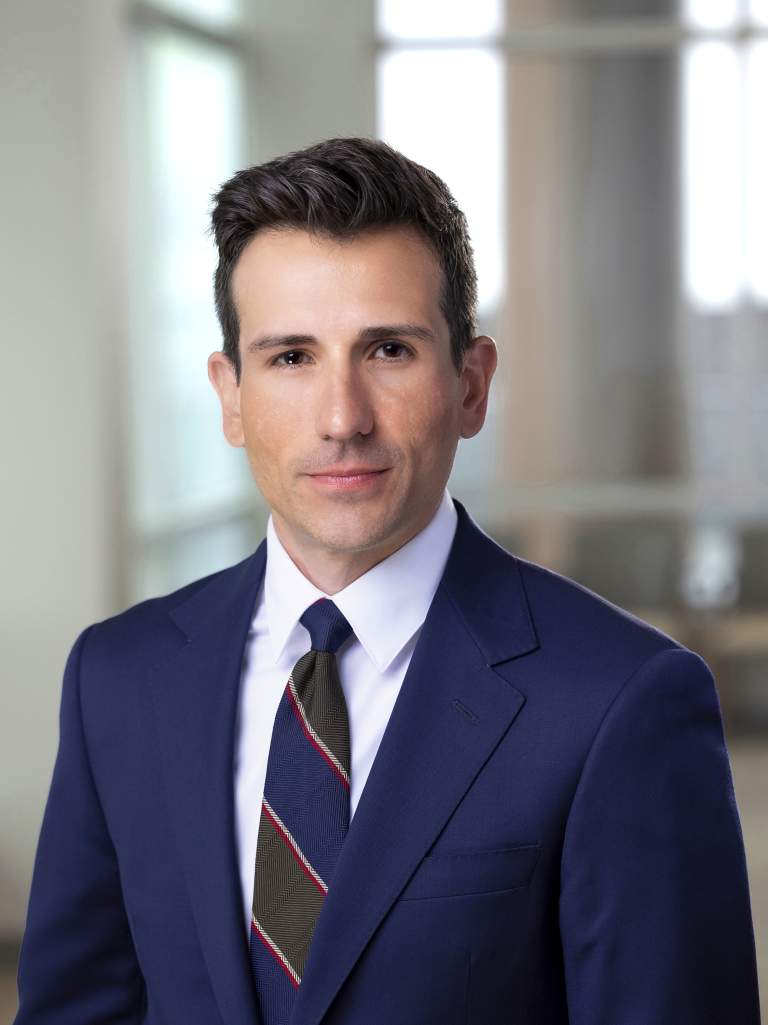 intense attorney in formal blue suit against high rise background