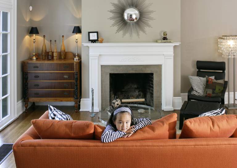 child on orange sofa