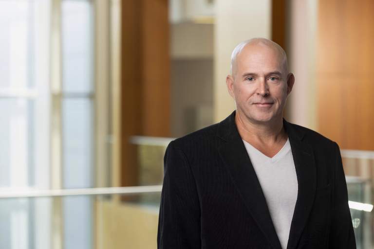 middle aged business executive in light filled atrium